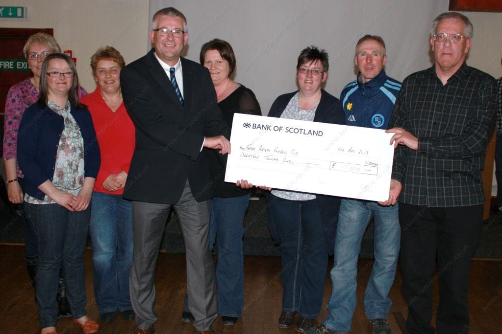 Supporters Club Committee presenting their cheque for £17,000 to Alastair Donald Supporters Club Committee with Alastair Donald